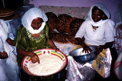 Eritrean women preparing hembesha - Eritrean bread