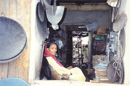 Female shopkeeper in a household utensils shop in Keren