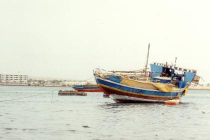 Canopy over the stern of a beached dhow frames sailing vessel