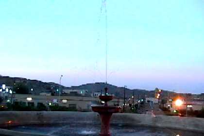 Illuminated fountain at sundown in the town circle of Nacfa